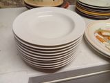 a stack of plates on a counter with a bunch of carrots on them