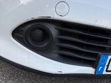 a close up of a white car with a license plate on it