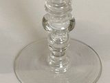a glass cup that is sitting on top of a table