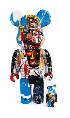 the bear is standing next to a small teddy bear with graffiti on it ' s body