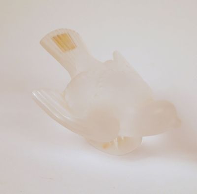 un oiseau en plastique posé sur une fourchette