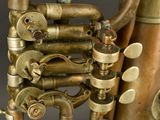 a very old brass instrument that is sitting on a table