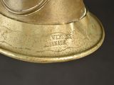 a brass bell on a black background with a black background