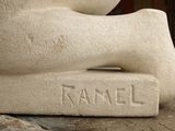 a stone statue of a person laying on the ground