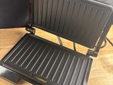 the grill is on the table next to the door