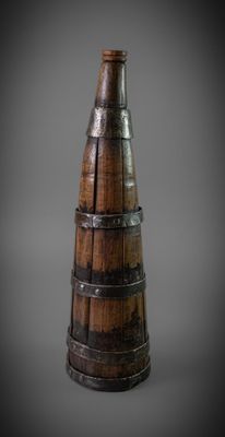 an image of a wooden wine bottle with a metal band around it
