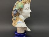 an image of a ceramic bust of a woman with grapes on her head