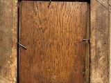 an old picture frame with a small wooden door in the middle of it