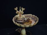 a bird bath with two birds sitting on top of it
