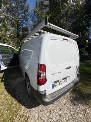 a white van that is parked next to a white van