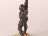 an image of a statue of a man lifting a barbell