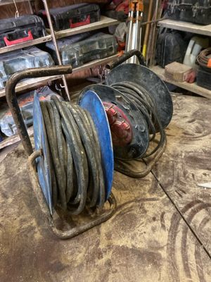 a picture of a reel and a hose in a garage
