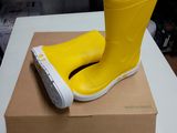 a yellow rubber boot on top of a box on a table