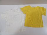 yellow and white t - shirts sitting on top of a white table