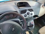 dashboard of a small car with a steering wheel and dashboard controls