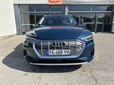 the front of a blue audi car parked in front of a building