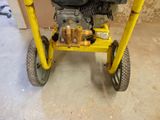 a small yellow cart with a small engine on it