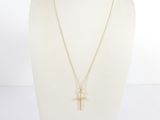 un collier avec une croix en or sur un mannequin, un mannequin, un mannequin, un mannequin, un mannequin, un mannequin, un mannequin, un mannequin, un manne