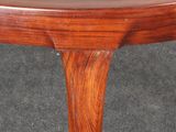 a wooden table with a wooden top on a carpeted floor