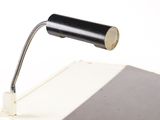 a black lamp that is on top of a book
