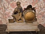 a statue of a man and a woman sitting on top of a clock