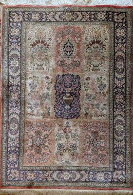 an antique persian rug with a medallion design on a beige ground