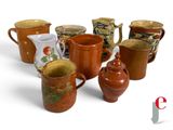 many different types of jugs and cups on the table