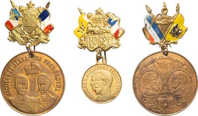 four medals of different countries are displayed on a white surface