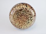 a close up of a ceramic object on a white surface