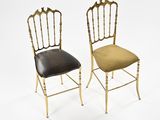 pair of gilded chairs with upholstered leather seats