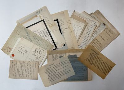 several old papers are stacked on top of each other on a table