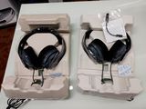 pair of black headphones sitting on top of a cardboard box