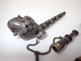 a metal pipe with a chain attached to it
