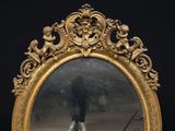a mirror that has a reflection of a person in it