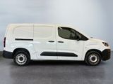 the white van is parked in a room with a gray floor