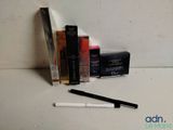 a pen that is sitting next to a box of makeup
