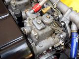 a close up of a motorcycle engine with a blue hose
