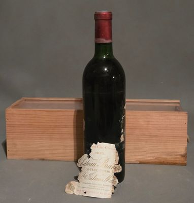 a bottle of wine sitting next to a wooden box