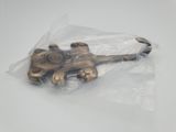 a metal object in a plastic bag on a white surface