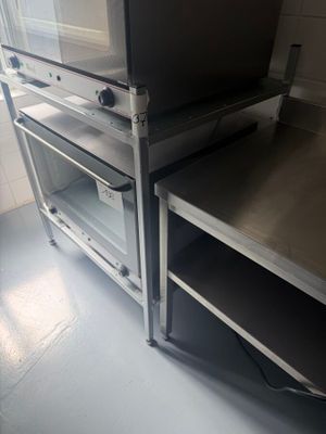 a silver oven sitting on top of a metal counter