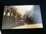 an old photo of a street with trees in it