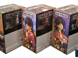 three boxes of anime figurines are stacked on top of each other