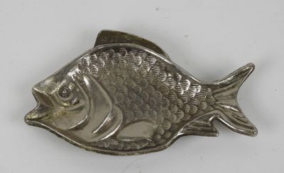 an image of a silver fish shaped object on a white surface