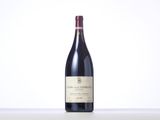the bottle of red wine is sitting on the table