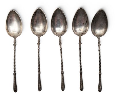 six spoons are lined up in a row on a white surface