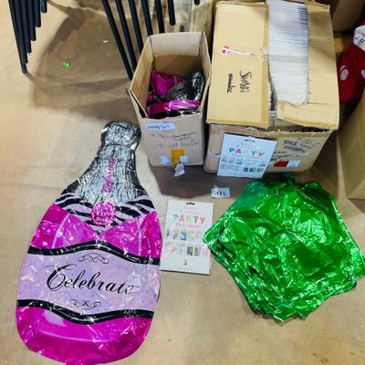 a bottle of champagne and a bunch of other items on the floor