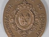 an image of a gold medal with a crown on it