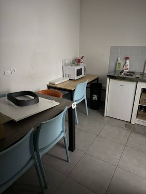 une petite cuisine avec une table et des chaises