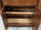 an image of a wooden bookcase with shelves