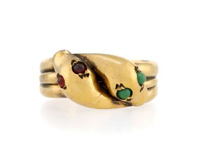 a close up of a gold ring with a snake on it ' s side